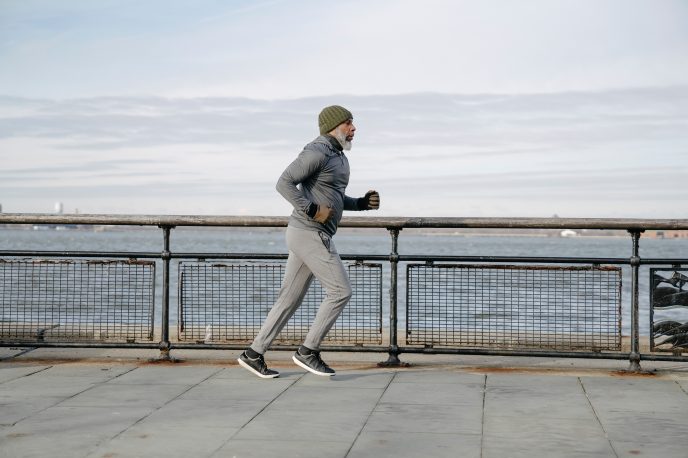 older man running to feel better and prevent injury